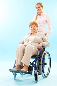 Young woman pushing wheelchair with elder woman