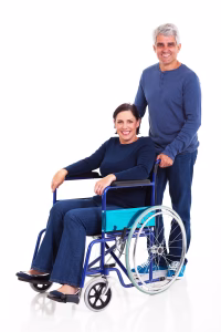 smiling middle aged man pushing handicapped wife on wheelchair isolated on white background