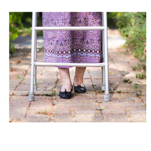 Bottom half of a walker visible with a ladies legs walking on cobblestones.