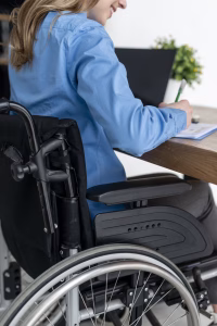 Close up of a woman working while sitting in a adjustable manual wheelchair