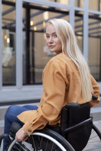 Woman outside in a folding ultra-light wheelchair
