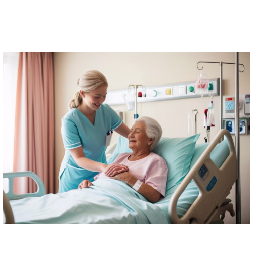 Female patient in a hospital bed with a nurse stood next to her. 